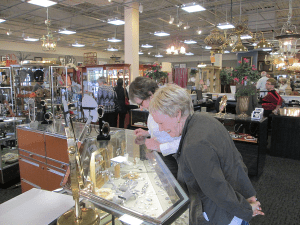 Shoppers browsing the jewelry display case