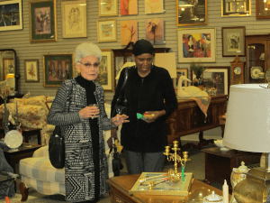 Shoppers exploring the art and furniture section