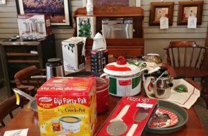 Assorted kitchen items including crock pots, pizza set, and small appliances