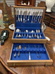 Silver flatware set in a wooden chest