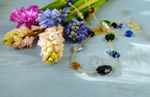 Gemstone necklace displayed with flowers