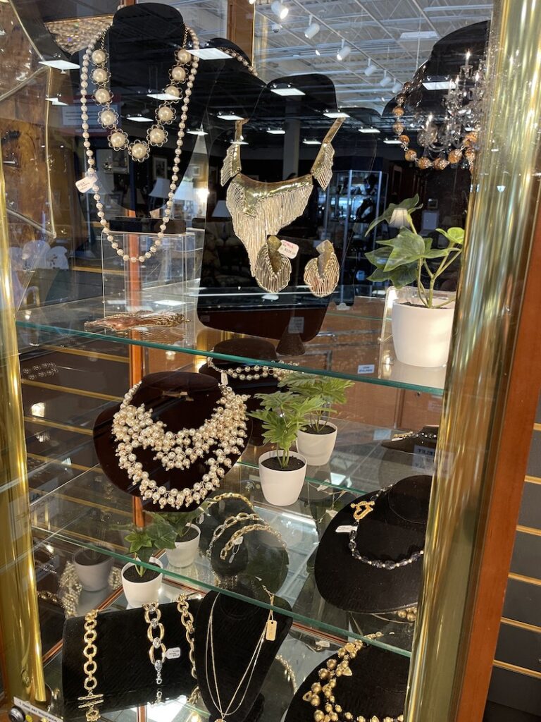 Glass display case with assorted necklaces and bracelets