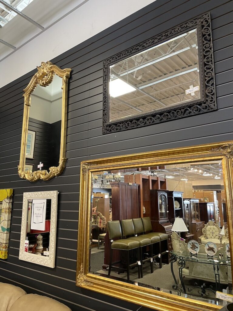 Decorative mirrors displayed on a slatwall